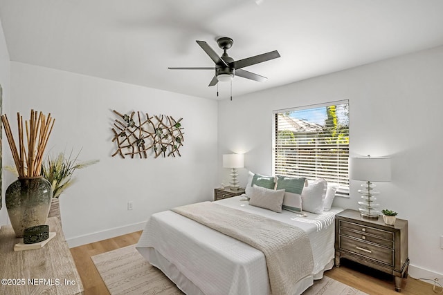 bedroom with ceiling fan and light hardwood / wood-style floors