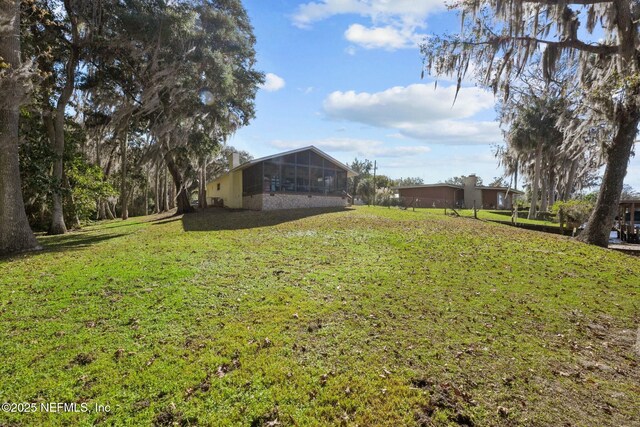 view of yard featuring a sunroom