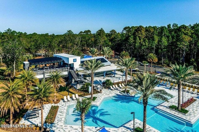 11107 Quasar Ct, Jacksonville, FL 32256 - community pool with a view of trees, stairs, and a patio