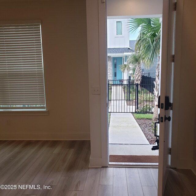 11107 Quasar Ct, Jacksonville, FL 32256 - entryway with baseboards and wood finished floors