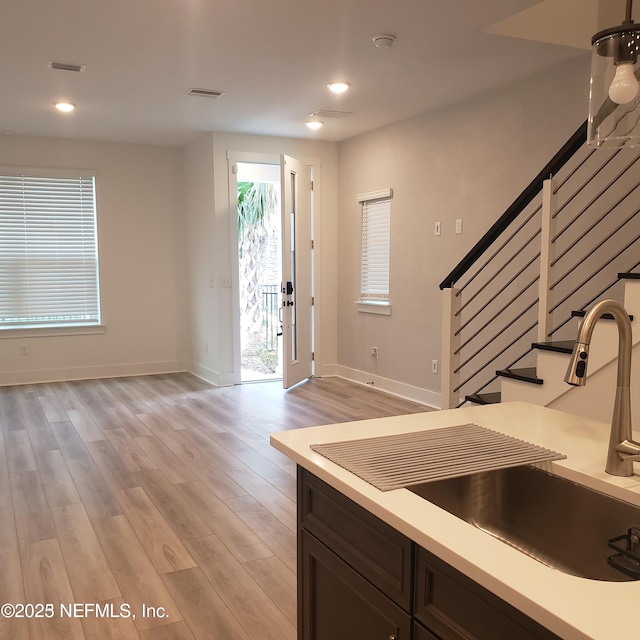 11107 Quasar Ct, Jacksonville, FL 32256 - entryway featuring baseboards, visible vents, light wood finished floors, and stairs