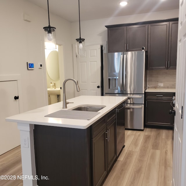 11107 Quasar Ct, Jacksonville, FL 32256 - kitchen featuring light countertops, stainless steel appliances, light wood-type flooring, and a sink