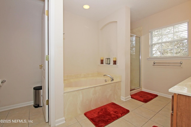 bathroom with tile patterned flooring, vanity, and independent shower and bath