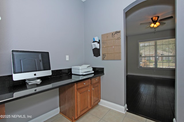 home office featuring light tile patterned flooring and ceiling fan