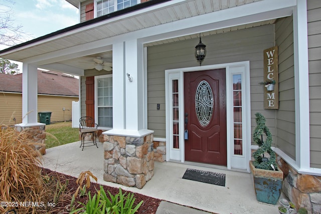 entrance to property featuring ceiling fan and a porch