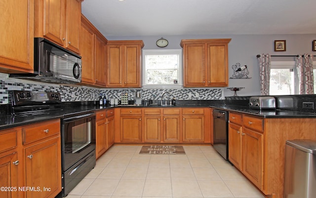 kitchen featuring sink, decorative backsplash, black appliances, and a healthy amount of sunlight