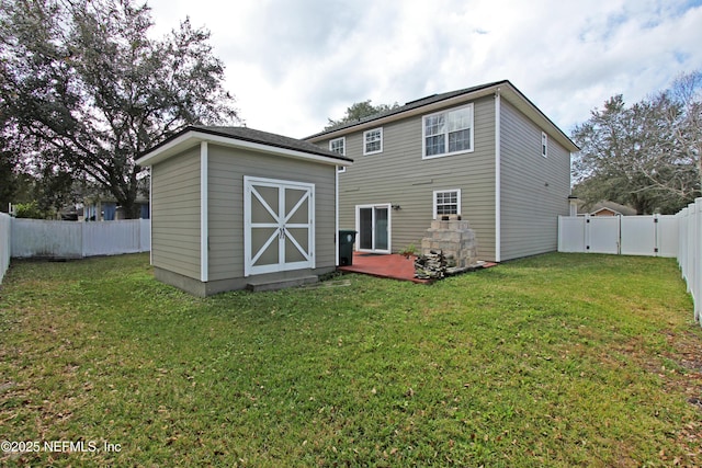 back of property with a storage unit and a lawn