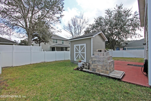 view of yard featuring a storage shed and a patio area