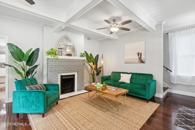 living room with beamed ceiling, wood-type flooring, crown molding, and ceiling fan