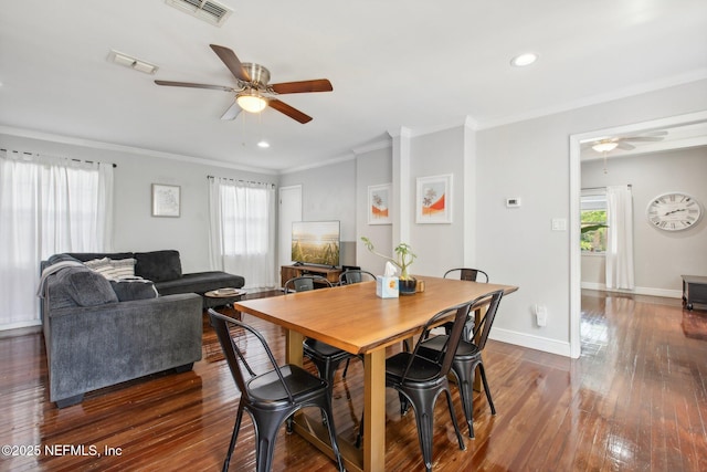 dining area featuring dark wood-type flooring, ceiling fan, plenty of natural light, and ornamental molding