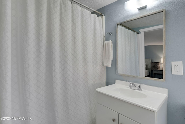 bathroom featuring vanity and a textured ceiling