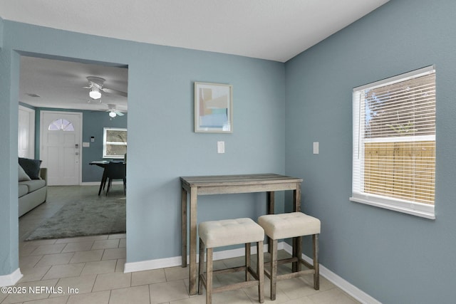 interior space featuring ceiling fan and light tile patterned floors