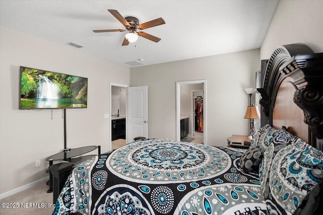 carpeted bedroom with ceiling fan and ensuite bathroom