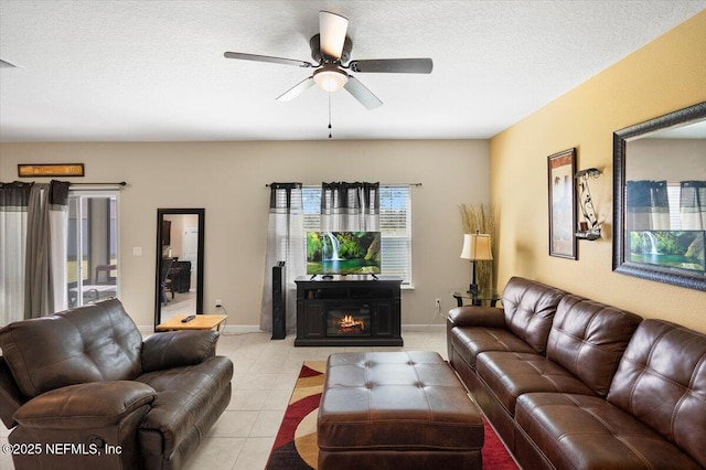 living room featuring light tile patterned flooring, a textured ceiling, and ceiling fan