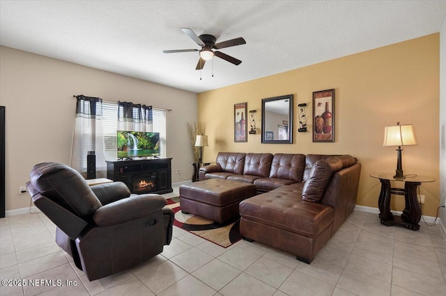 living room featuring light tile patterned floors, a textured ceiling, and ceiling fan