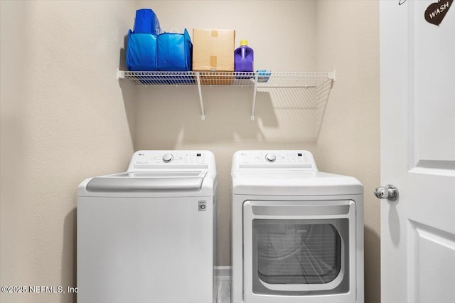 laundry room with washing machine and clothes dryer