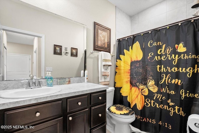 bathroom with vanity, toilet, and curtained shower