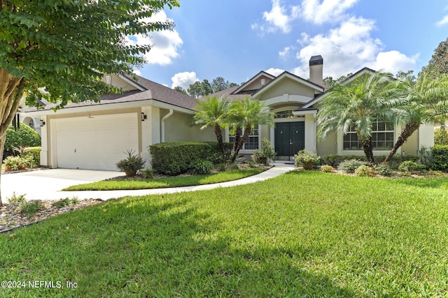 view of front of home with a garage and a front yard