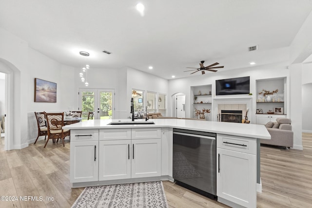 kitchen with french doors, sink, light hardwood / wood-style flooring, dishwasher, and white cabinets