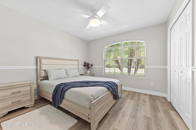 bedroom featuring a closet, ceiling fan, and light wood-type flooring