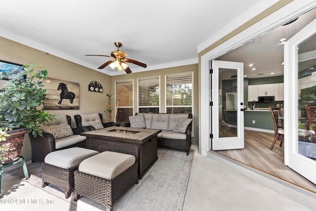 living room featuring crown molding and ceiling fan