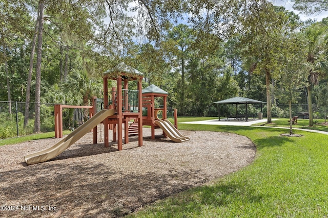 view of playground with a gazebo and a lawn