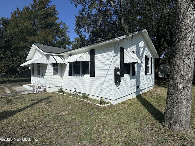 view of property exterior with a yard