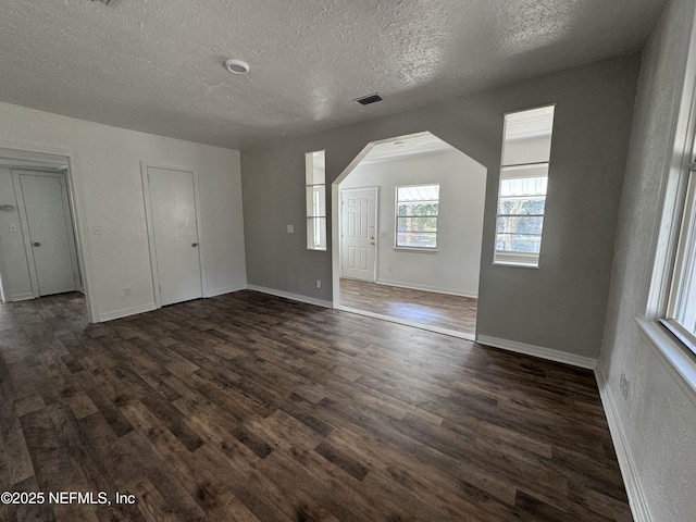 interior space featuring dark hardwood / wood-style flooring and a textured ceiling