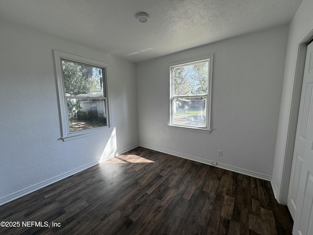 unfurnished bedroom featuring dark wood-type flooring and a textured ceiling