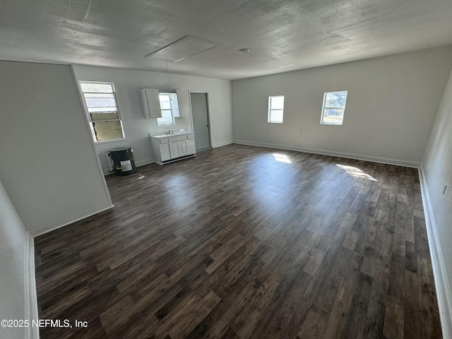 empty room with dark hardwood / wood-style flooring and a textured ceiling