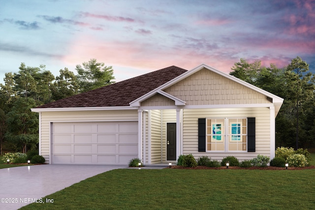 view of front of home with a garage and a lawn