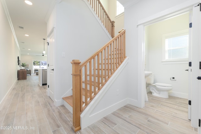 stairway featuring crown molding