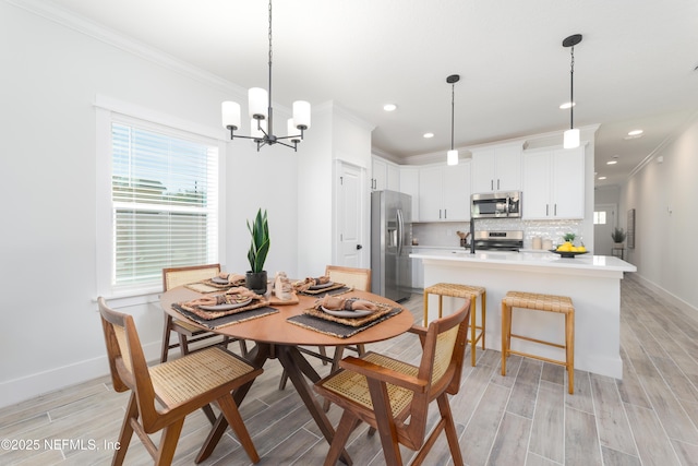 dining area featuring crown molding and an inviting chandelier