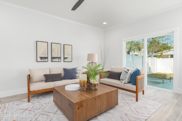 living room featuring crown molding and light wood-type flooring