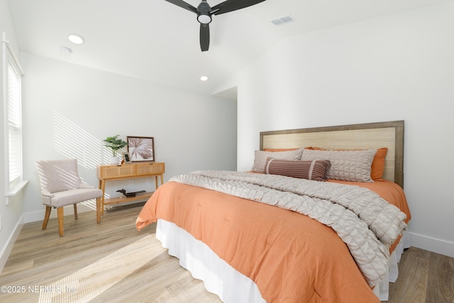 bedroom featuring ceiling fan, lofted ceiling, and light wood-type flooring