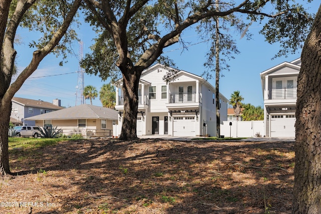 view of front of house featuring a balcony and a garage