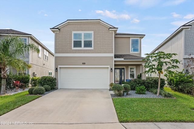 view of front of home featuring a garage and a front lawn