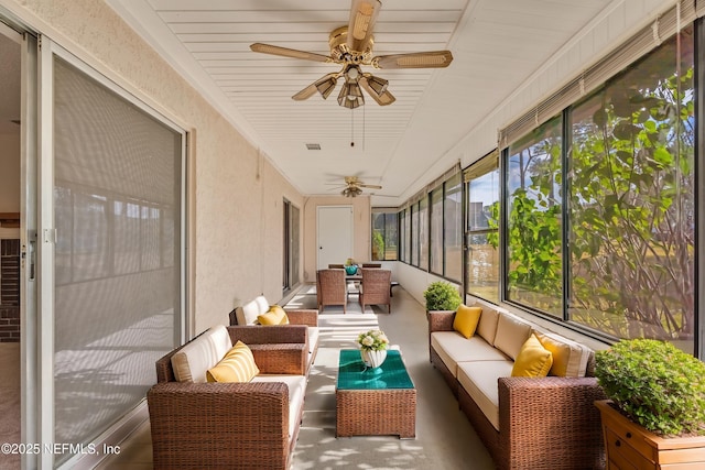 sunroom featuring ceiling fan