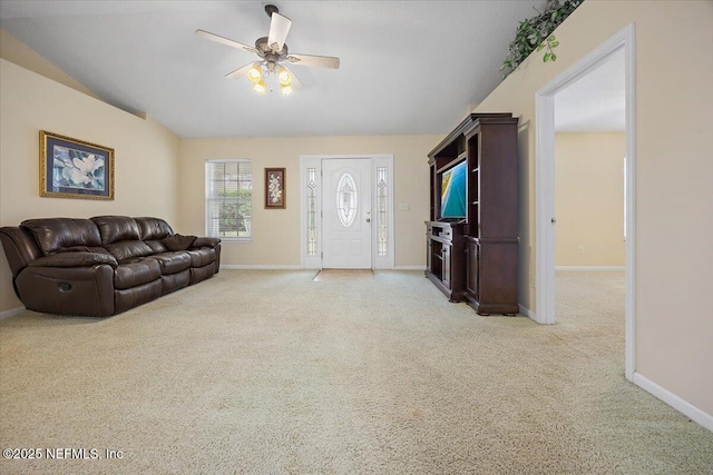 carpeted living room with ceiling fan and lofted ceiling