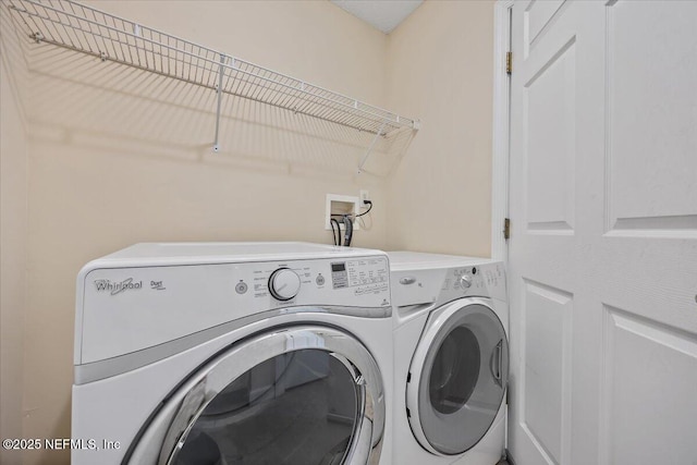 washroom featuring washing machine and dryer