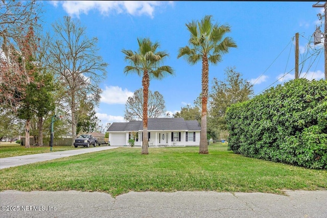 view of front of property featuring a garage and a front yard