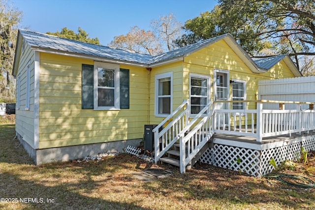 back of house with a wooden deck