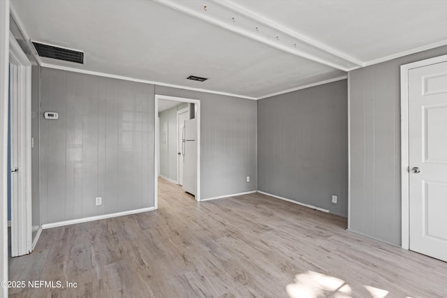 unfurnished bedroom featuring ornamental molding, light hardwood / wood-style floors, and white fridge