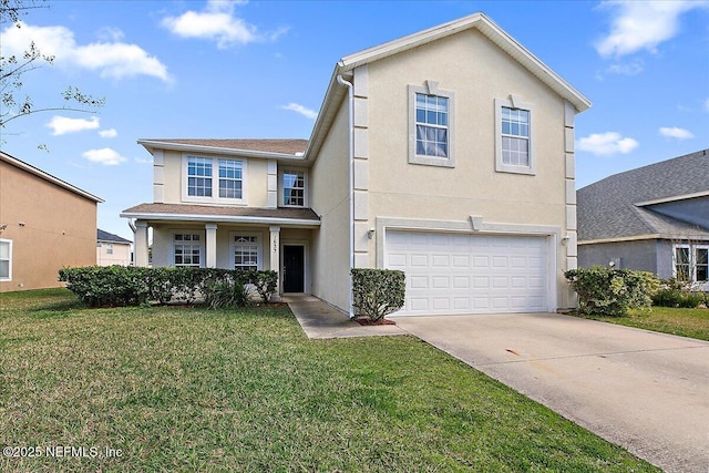 traditional-style home featuring a front yard, concrete driveway, and stucco siding