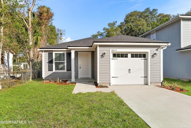 view of front of property featuring a garage and a front lawn