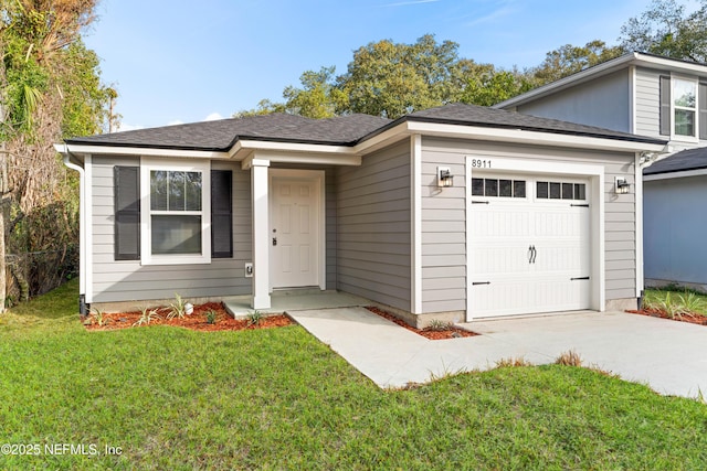 view of front facade with a garage and a front lawn