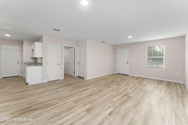 unfurnished living room featuring light hardwood / wood-style floors