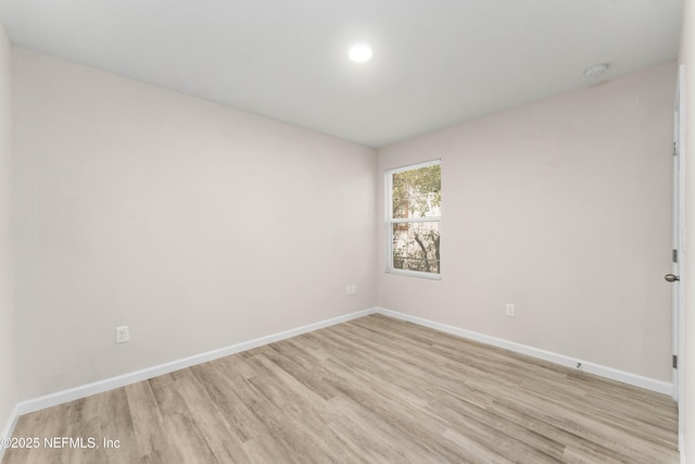 spare room featuring light hardwood / wood-style flooring