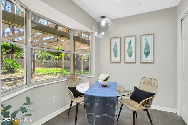 dining space with dark tile patterned floors