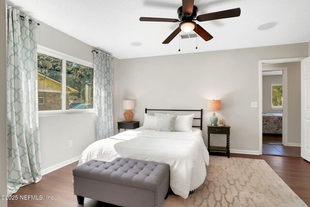 bedroom featuring dark hardwood / wood-style flooring and ceiling fan